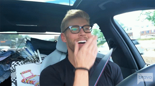 Man With Glasses Sitting in Car With Bravo