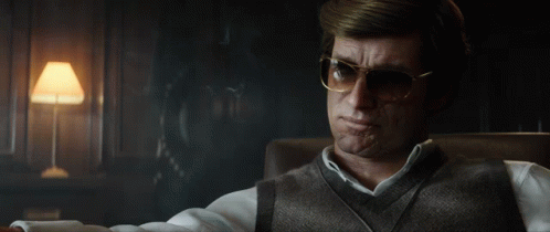 Man with Glasses Sitting in Chair Smoking Cigarette