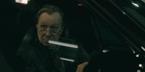 Man With Glasses Sitting In Dark Car GIF