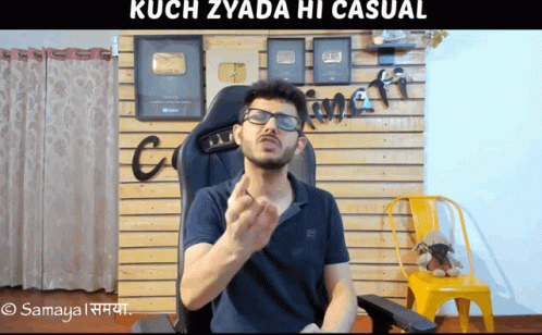 Man With Glasses Sitting In Front Of Kuch Zyada Hi Casual Wall GIF
