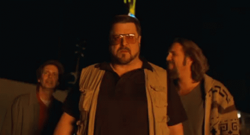 Man with Glasses Standing by Fuck You Neon Sign