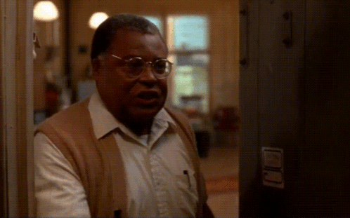 Man With Glasses Standing In Hallway GIF