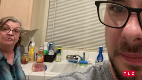 Man With Glasses Taking Selfie With Woman in Kitchen TLC