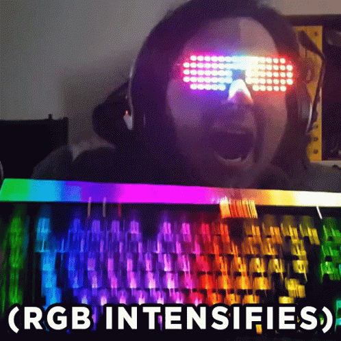 Man with Glowing Glasses at Rainbow Keyboard
