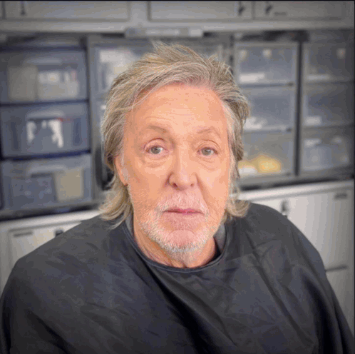 Man With Gray Hair and Beard in Black Cape