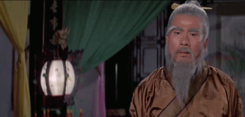 Man With Gray Hair and Beard in Brown Robe