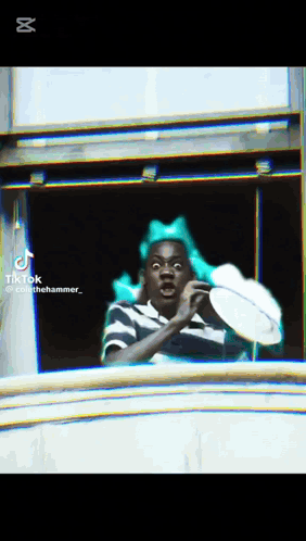 Man With Green Bow Looking Out Window GIF