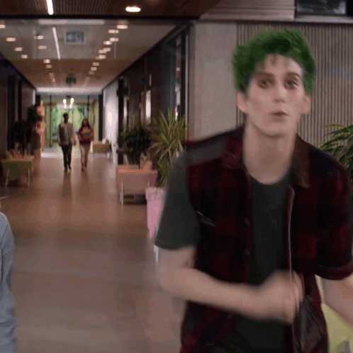 Man With Green Hair and Plaid Vest Walking