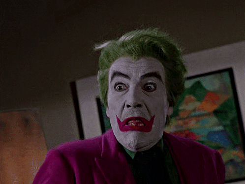 Man with Green Hair and White Face Paint in Purple Jacket