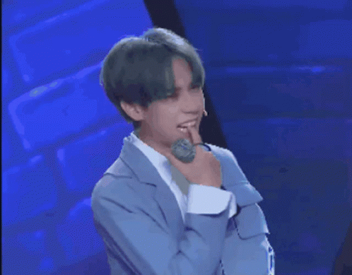Man with Green Hair Holding Microphone and Question Mark