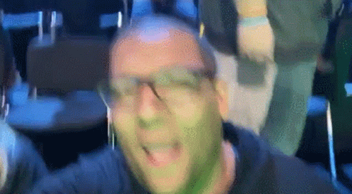 Man With Green Paint on Face Wearing Headphones