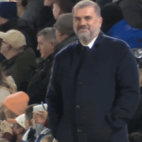 Man With Hands in Pockets in Crowd