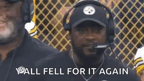 Man With Hat and Headphones Talking Into Microphone Watching Football