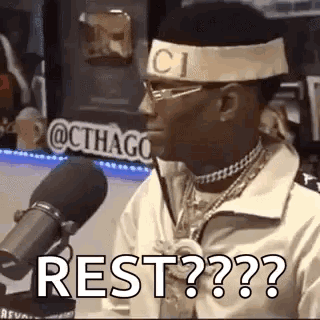 Man With Headband and Glasses Saying Rest at Mic
