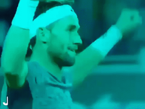 Man With Headband and Wristbands Raising Arms Tennis