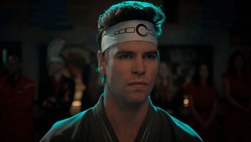 Man With Headband Letter C Looking At Camera GIF