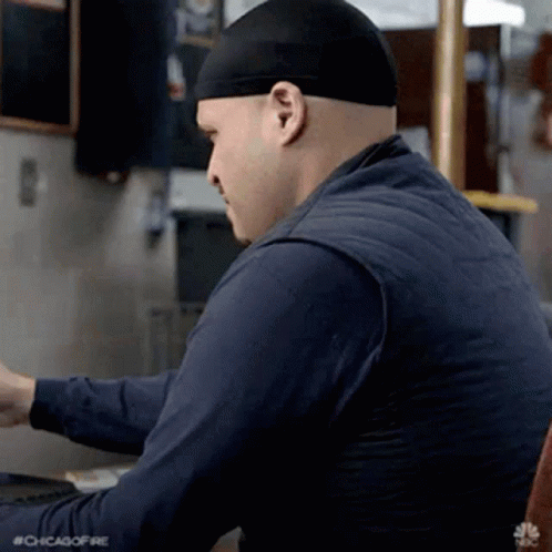 Man With Headband Using Computer GIF