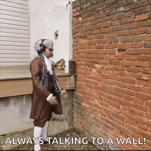 Man with Headphones Always Talking to Wall