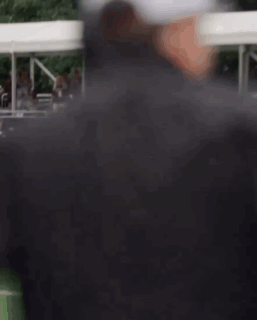 Man With Headphones and Baseball Cap on Field