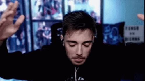Man with Headphones and Black Hoodie Sitting at Computer