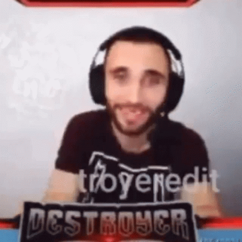 Man with Headphones and Destroyer Sign in Front of Screen