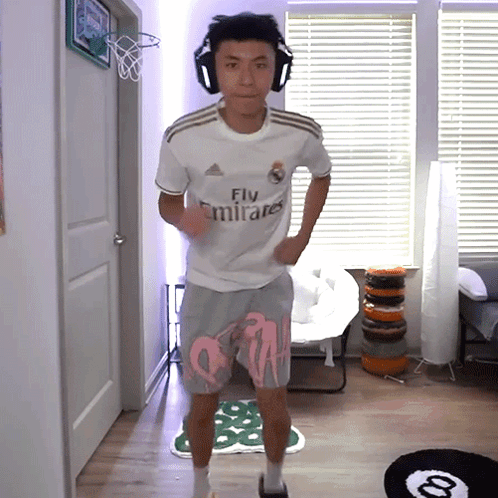 Man With Headphones And Fly Emirates Jersey GIF