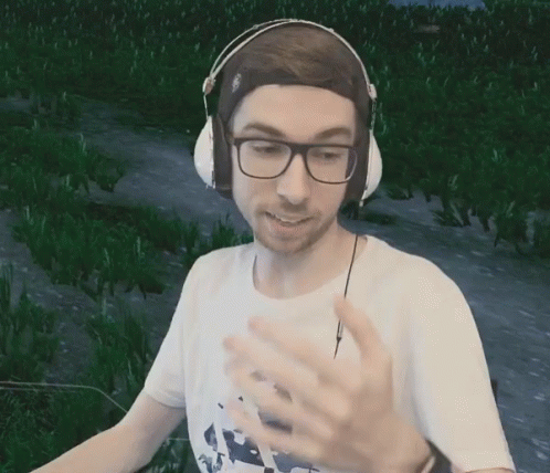 Man With Headphones and Glasses in Green Field