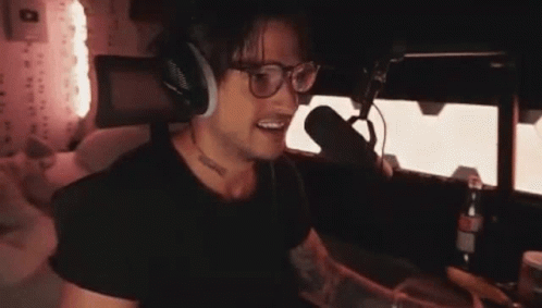 Man With Headphones And Glasses Talking Into Microphone GIF