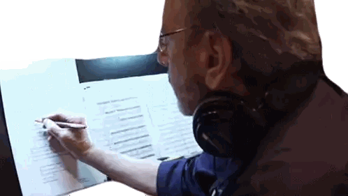 Man With Headphones and Glasses Writing