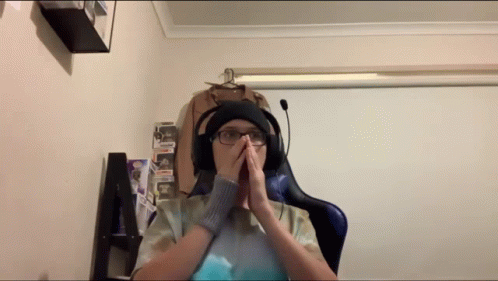 Man With Headphones and Hat Hands on Face