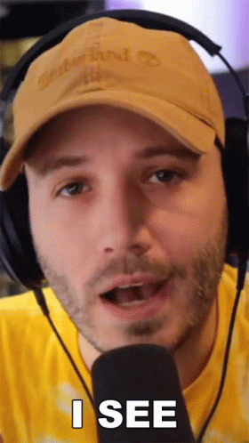 Man With Headphones and Hat Saying I See at Microphone