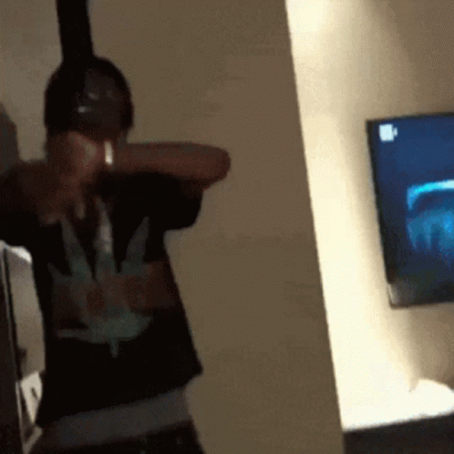 Man With Headphones and Marijuana Shirt at TV