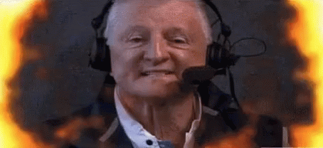 Man with Headphones and Microphone Surrounded by Flames