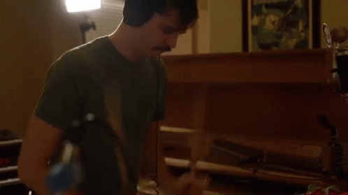 Man With Headphones And Mustache Playing Piano GIF
