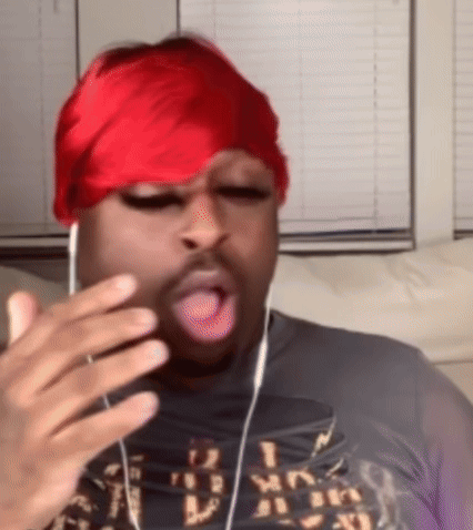 Man With Headphones and Red Headband Making Funny Face