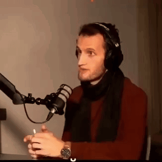 Man With Headphones And Scarf Talking Into Mic GIF
