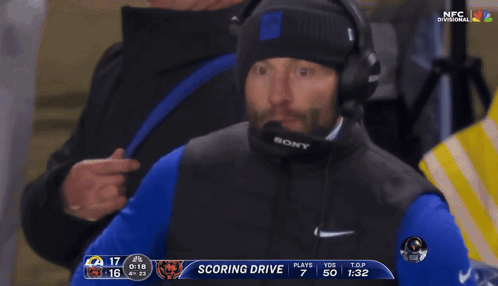 Man With Headphones and Sony Microphone Watching Football