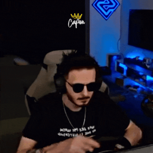 Man With Headphones And Sunglasses In Front Of Capon Sign GIF