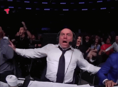 Man With Headphones and Tie in Front of Crowd