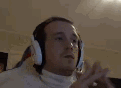 Man With Headphones And White Turtleneck Listening To Music GIF