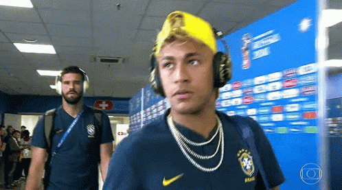 Man With Headphones And Yellow Hat Walking GIF