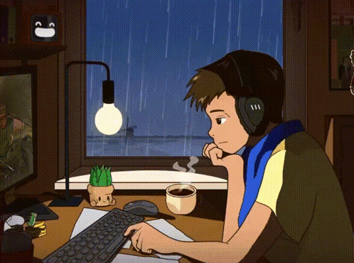 Man With Headphones At Desk With Computer And Coffee GIF