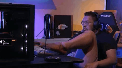 Man with Headphones at GSkill Computer Desk