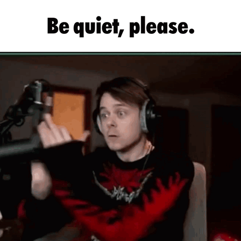 Man With Headphones at Microphone Says Be Quiet Please