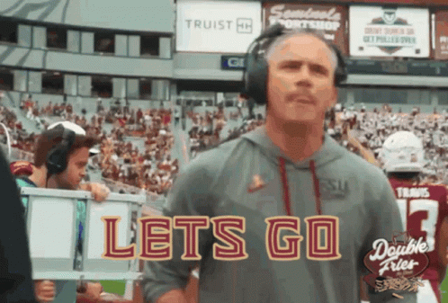 Man With Headphones Before Lets Go Sign