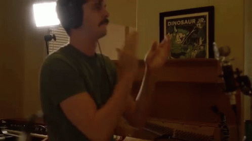 Man With Headphones Clapping In Front Of Dinosaur Jr. Picture GIF