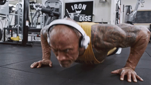 Man With Headphones Doing Push Ups Iron Dise Sign GIF