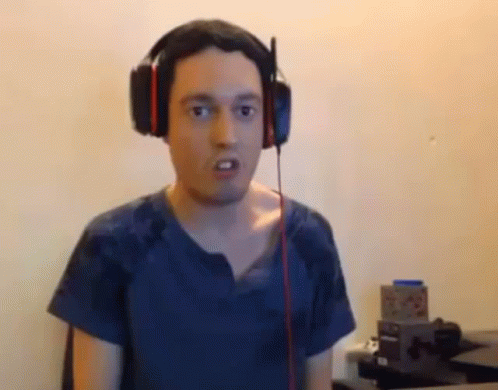 Man With Headphones Funny Face at Desk