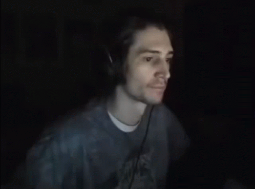 Man with Headphones Funny Face in Dark Room