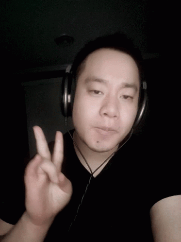 Man with Headphones Giving Peace Sign
